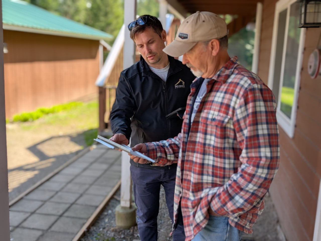 New Heights Roofing inspector reviewing report with homeowner